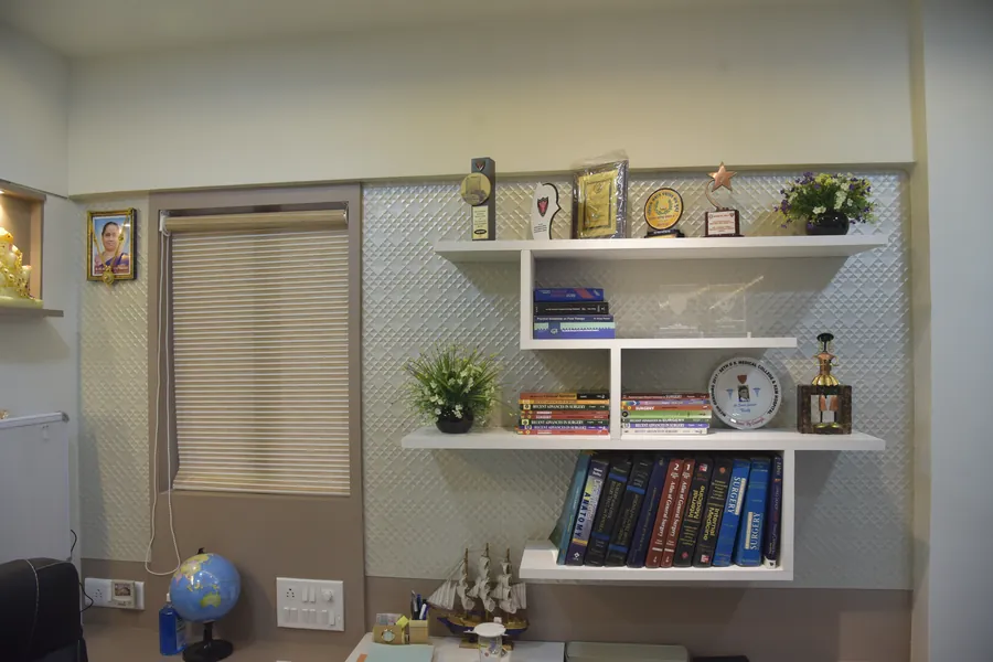 Shelves of surgical textbooks and awards